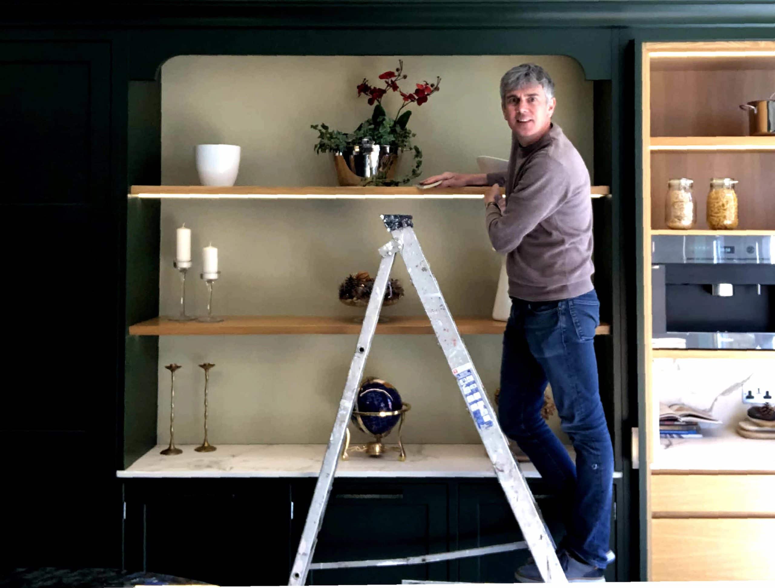   Darren Taylor in the Searle & Taylor Winchester showroom with his newly painted kitchen display  in Farrow & Ball’s Duck Green